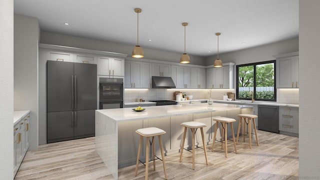 kitchen featuring black appliances, a center island, a kitchen bar, and gray cabinetry