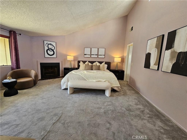 bedroom with high vaulted ceiling, carpet floors, and a textured ceiling