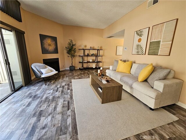 living room with dark wood-type flooring and a textured ceiling