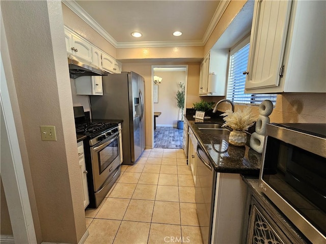 kitchen with crown molding, white cabinets, and appliances with stainless steel finishes