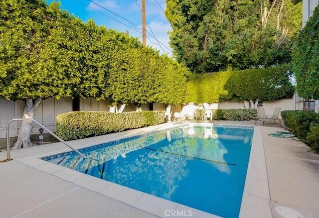 view of swimming pool with a patio area