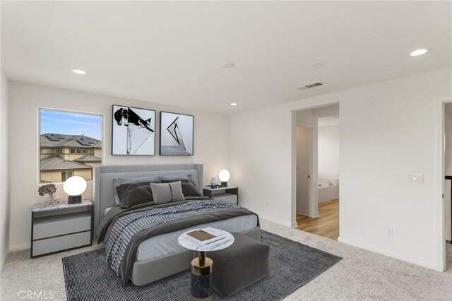 bedroom featuring light colored carpet