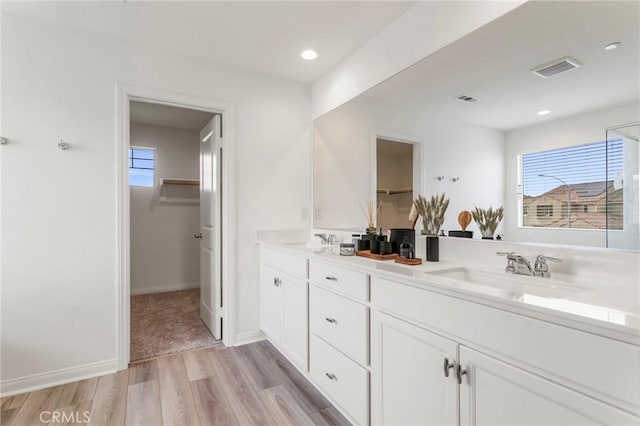 bathroom with vanity and hardwood / wood-style floors