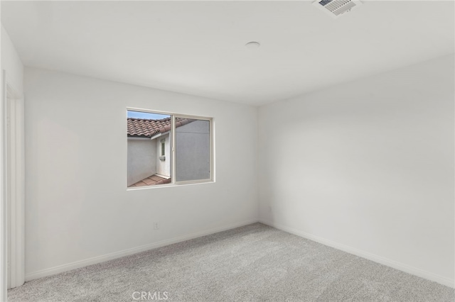 unfurnished room with light carpet