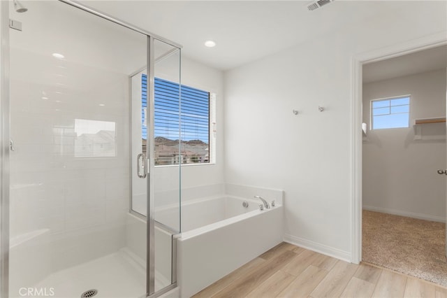 bathroom with separate shower and tub and hardwood / wood-style floors