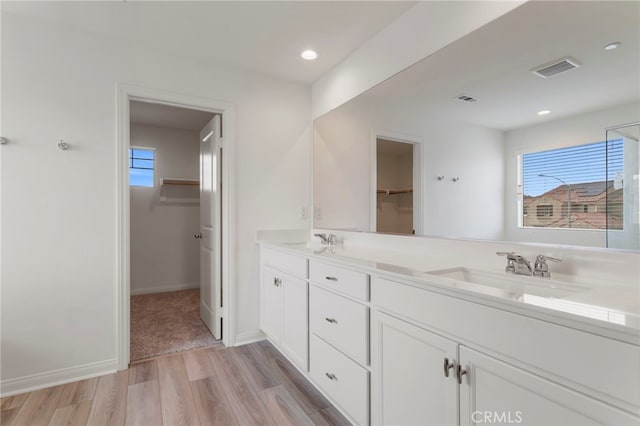 bathroom with vanity, hardwood / wood-style floors, and plenty of natural light