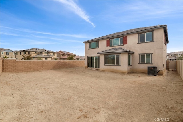 rear view of property with central AC unit