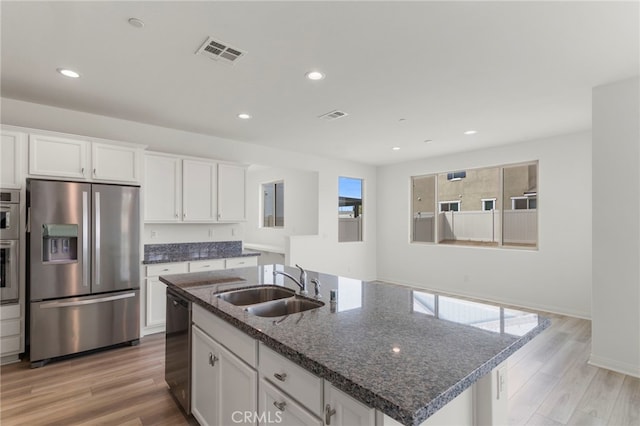 kitchen featuring white cabinetry, a kitchen island with sink, and stainless steel fridge with ice dispenser