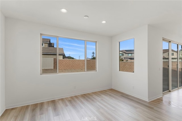 unfurnished room with light hardwood / wood-style flooring