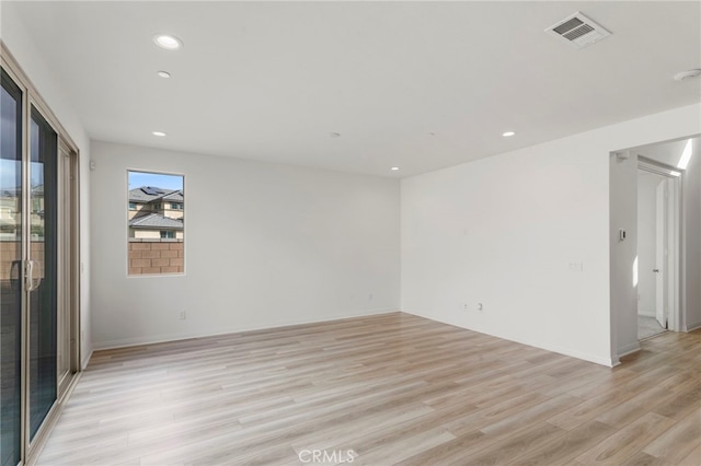 empty room with light hardwood / wood-style flooring