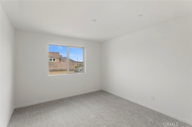 unfurnished room featuring carpet flooring