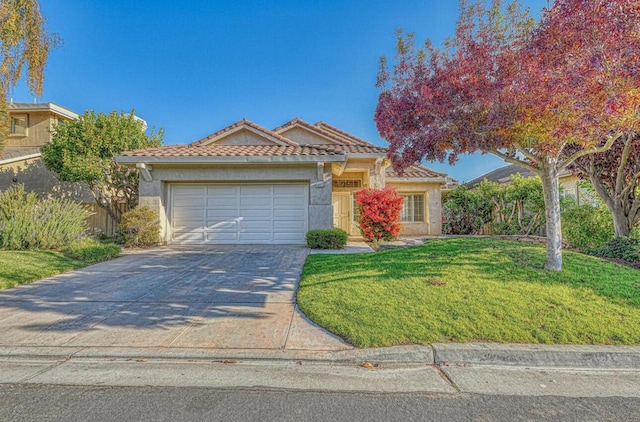 view of front of property with a garage and a front yard