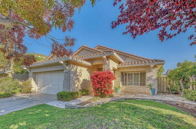 view of front of home with a front yard and a garage