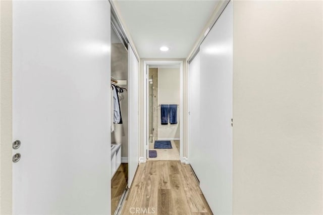 corridor with light hardwood / wood-style flooring