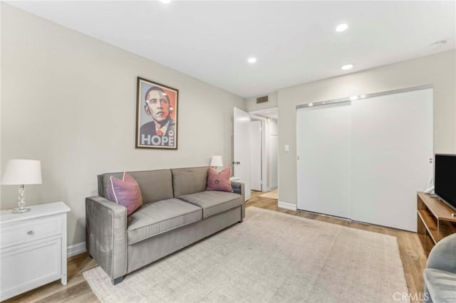 living room with light hardwood / wood-style flooring