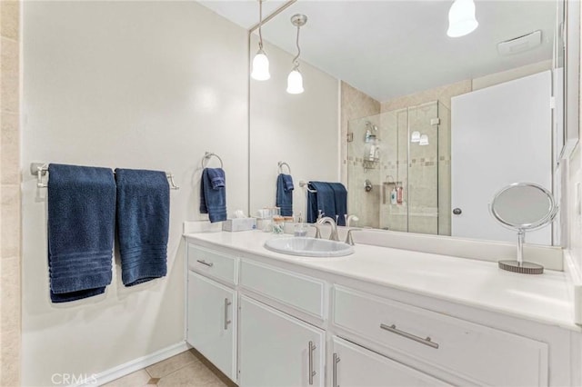 bathroom featuring tile patterned flooring, vanity, and walk in shower