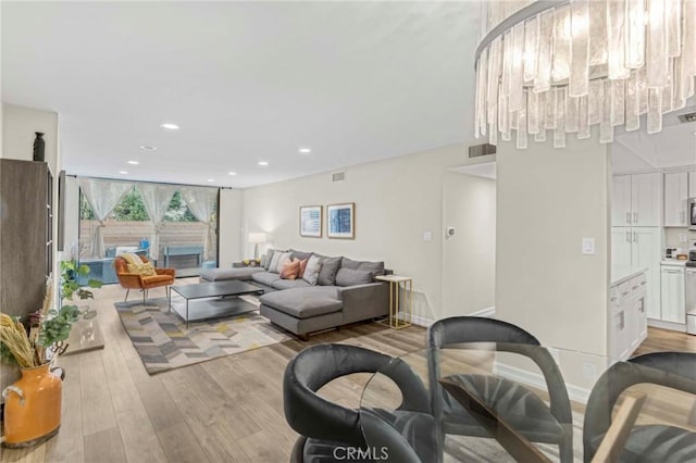 living room featuring a fireplace and light hardwood / wood-style flooring