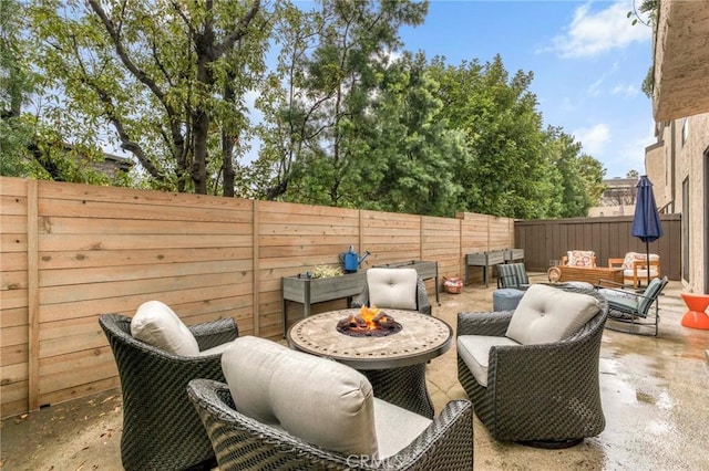 view of patio / terrace featuring an outdoor living space with a fire pit