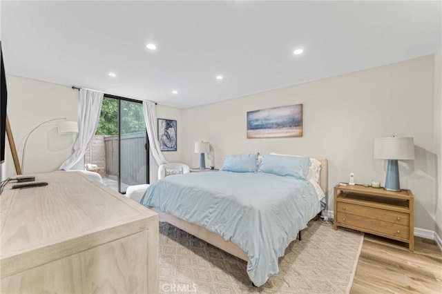 bedroom with access to exterior and light hardwood / wood-style flooring