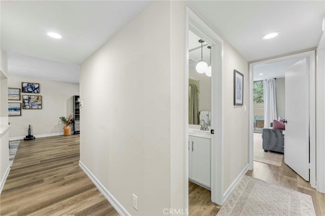 hall featuring sink and light hardwood / wood-style flooring