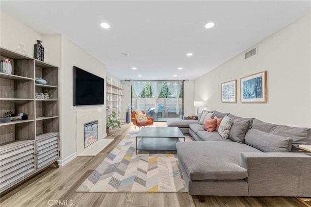 living room featuring light hardwood / wood-style floors and expansive windows