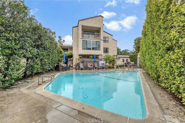 view of pool featuring a patio area