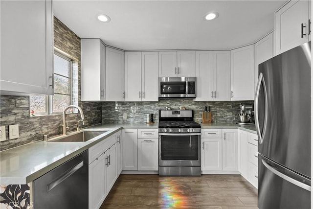 kitchen featuring white cabinetry, stainless steel appliances, dark hardwood / wood-style floors, and sink