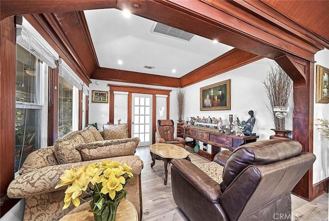 living room with light wood-type flooring and ornamental molding