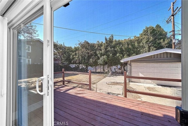 deck featuring an outbuilding and a garage