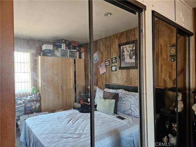 bedroom with wood walls