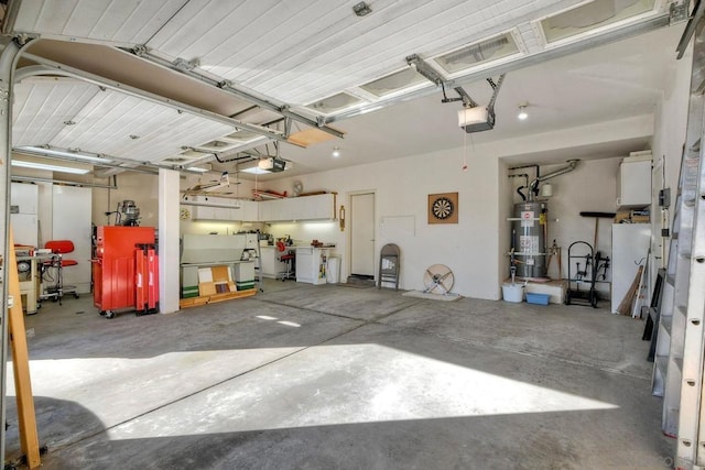 garage featuring strapped water heater and a garage door opener