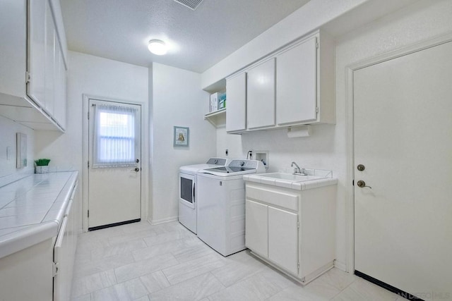 laundry area featuring cabinets and separate washer and dryer