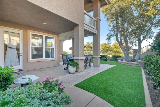 view of yard featuring a patio and a balcony