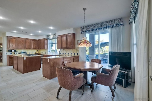 kitchen featuring tasteful backsplash, a kitchen island, and pendant lighting