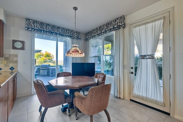 dining area featuring light tile patterned floors and plenty of natural light