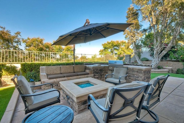 view of patio featuring an outdoor kitchen and an outdoor living space with a fire pit