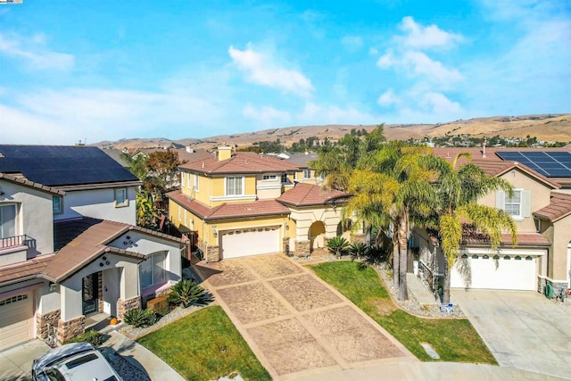 view of front facade featuring a mountain view and a garage