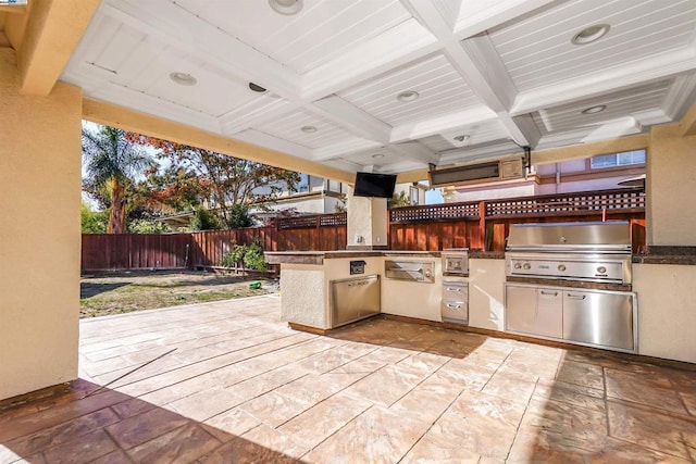 view of patio with area for grilling and exterior kitchen