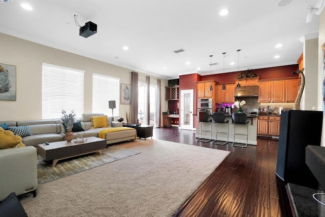 living room with dark hardwood / wood-style floors and crown molding