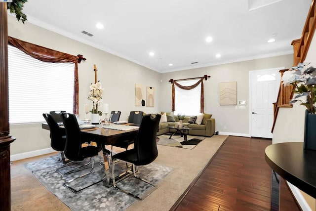 dining space featuring dark hardwood / wood-style flooring and crown molding