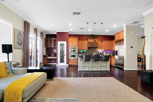 living room featuring crown molding, sink, and dark hardwood / wood-style floors