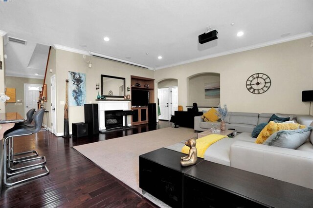 living room with dark hardwood / wood-style flooring and ornamental molding