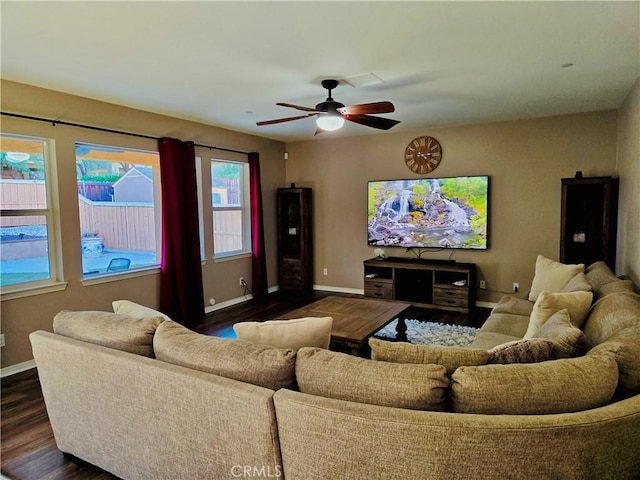 living room with ceiling fan and dark hardwood / wood-style flooring