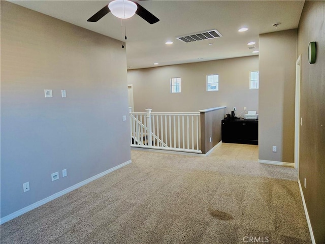 carpeted empty room with ceiling fan