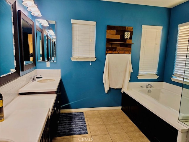 bathroom with tile patterned flooring, vanity, and a bath