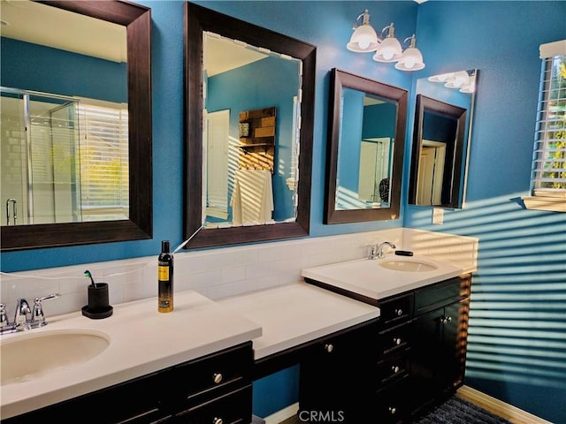 bathroom with vanity and a shower with door