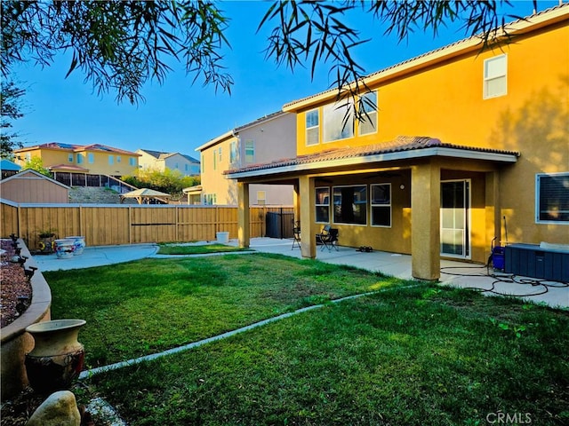 rear view of property with a patio area and a yard