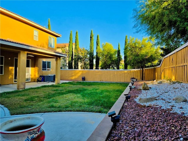 view of yard with a patio and central AC unit