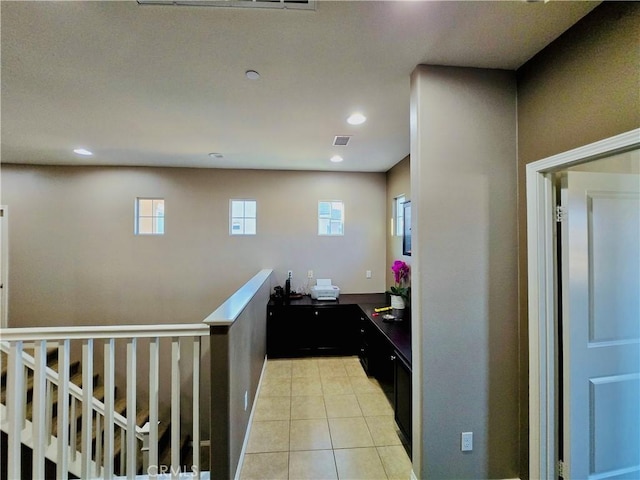 hall with light tile patterned floors