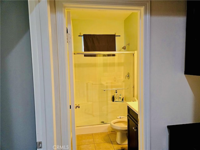 bathroom featuring tile patterned flooring, vanity, a shower with shower door, and toilet